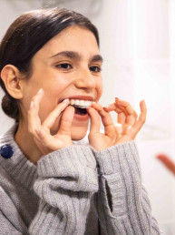 girl putting invisible aligners on
